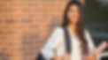 High school girl smiling and holding textbooks