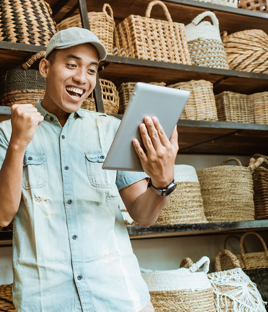 Excited young man looking at an tablet