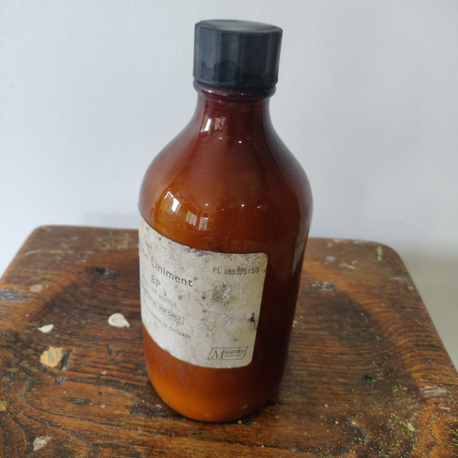 Vintage 1950s white liniment (some contents remain) apothecary/ chemist bottle