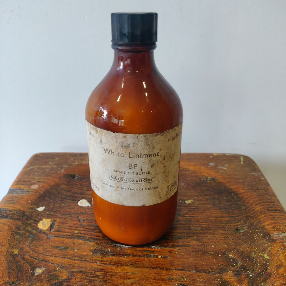 Vintage 1950s white liniment (some contents remain) apothecary/ chemist bottle