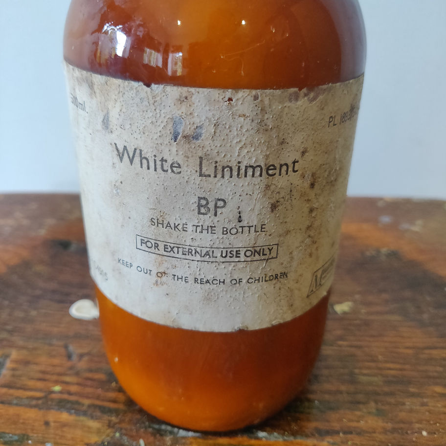 Vintage 1950s white liniment (some contents remain) apothecary/ chemist bottle