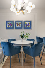 Living room with butterfly art in blue and grey tones