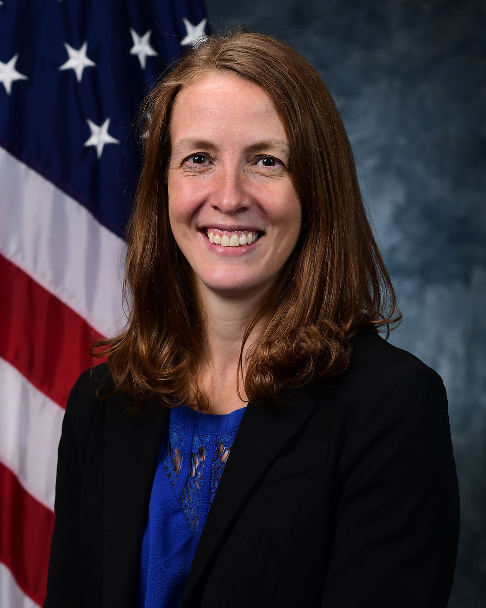Smiling woman in a blazer with an American flag