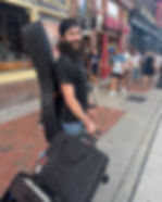 Mike Martin in Nashville with guitar case and luggage on Broadway