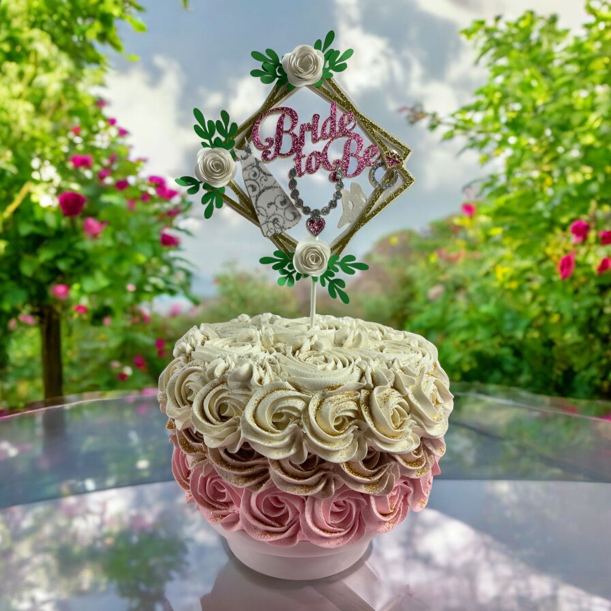 Bachelorette cake topper with 'Bride to Be' text, featuring a bridal dress cutout, shoes, necklace, ring, and floral accents.