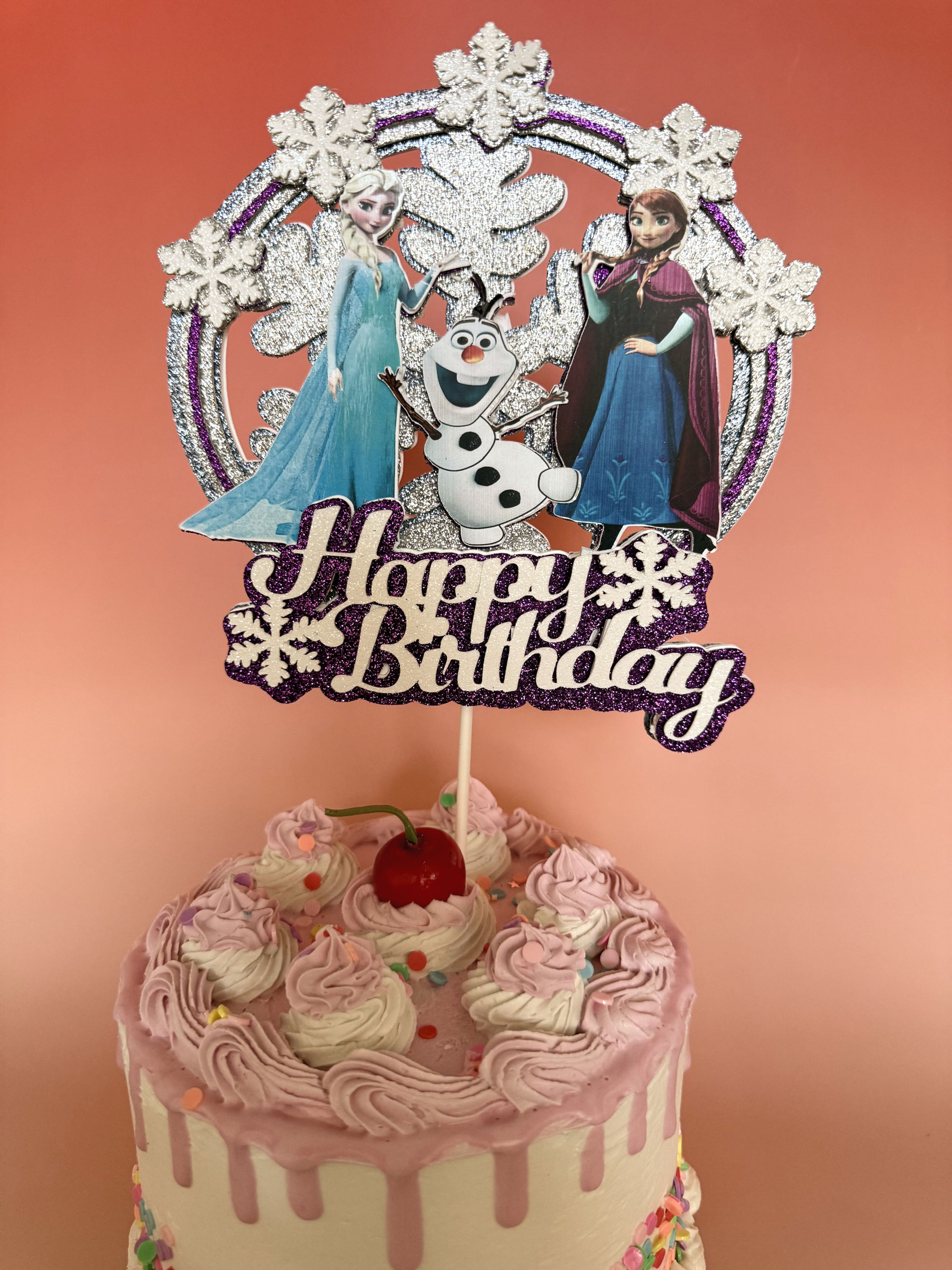 Frozen-themed cake topper featuring Elsa and Anna, with icy details and vibrant colors, perfect for a magical birthday celebr