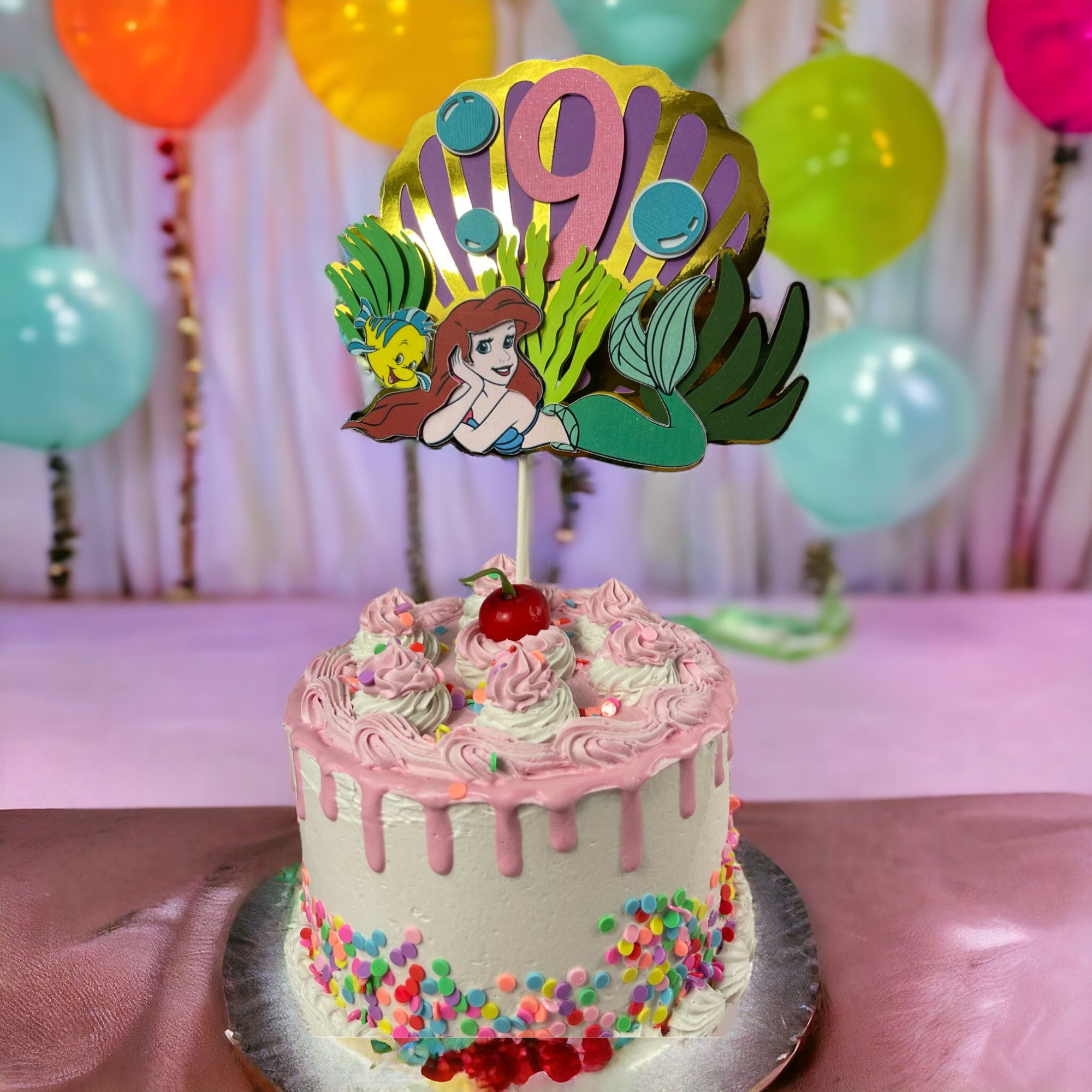 riel-themed cake topper showcasing mermaid princess with flowing red hair, a sparkling tail, and under-the-sea details