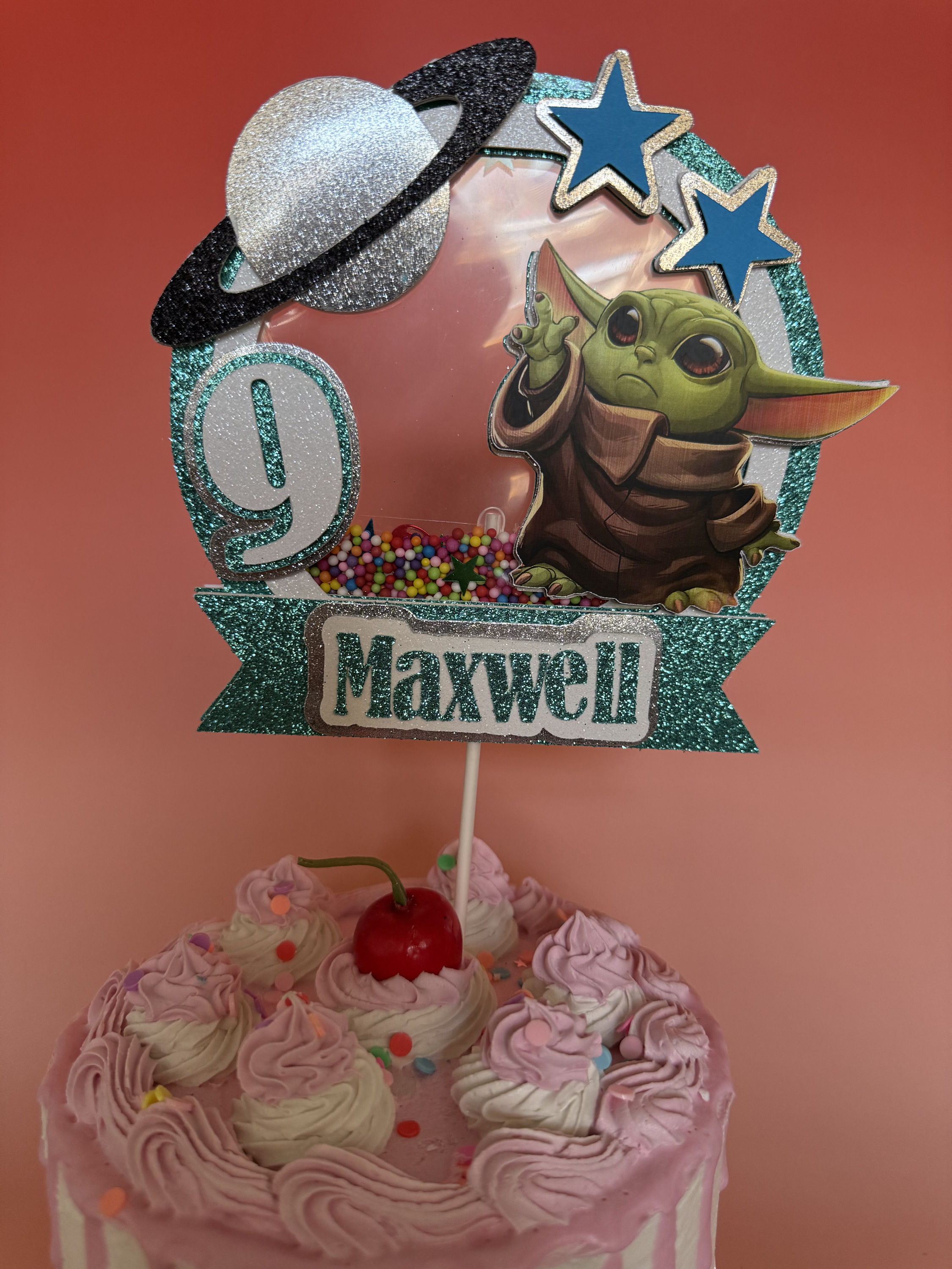 Adorable Baby Yoda cake topper with his big ears and sweet expression, perfect for adding a touch of Star Wars magic to any b