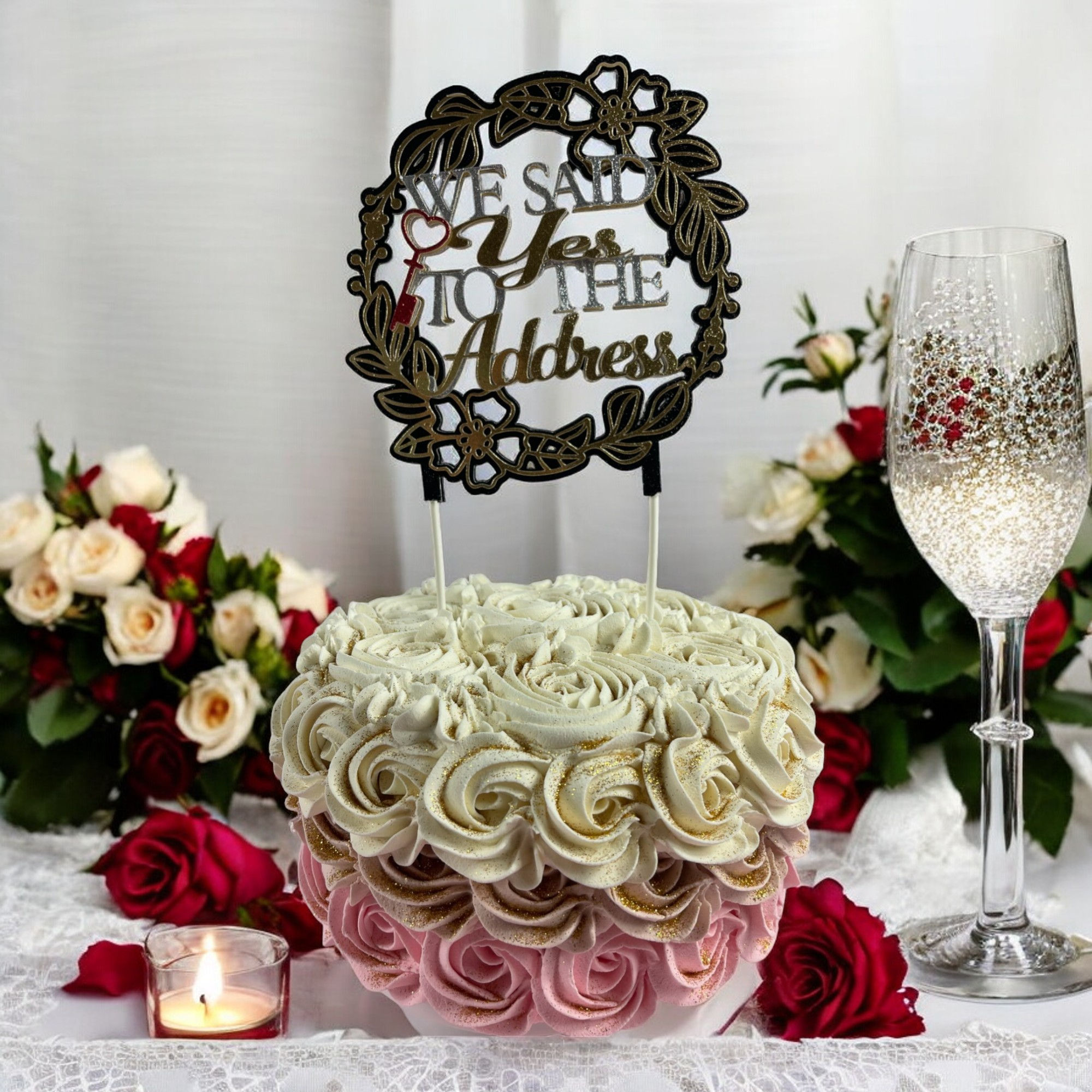 Wedding engagement cake topper with 'We Said Yes to the Address' text and floral design, symbolizing a new home together.
