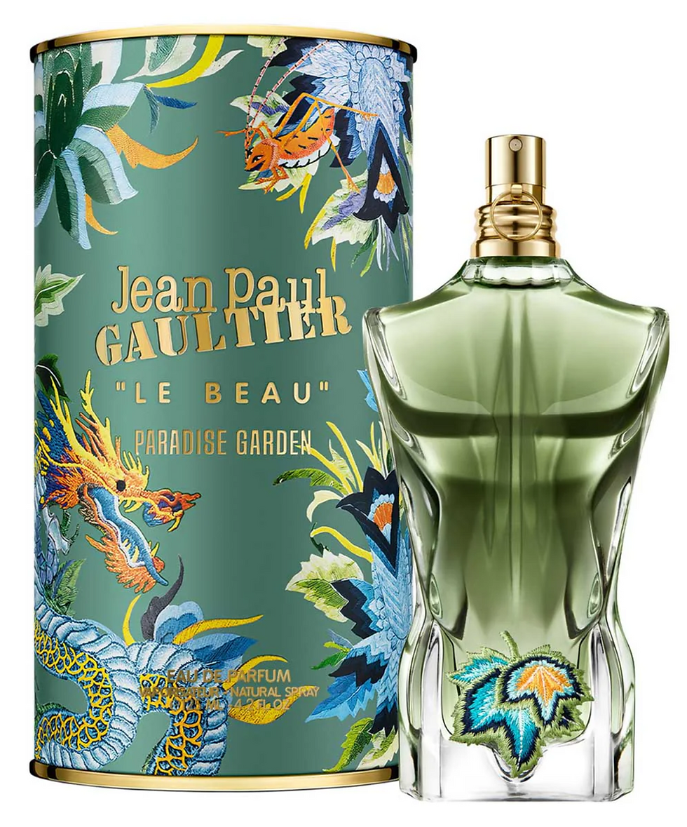 Jean Paul Gaultier Le Beau Paradise Garden perfume bottle in front of floral design