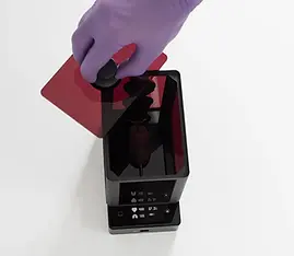 MARTA box with MARTA pad as heated floor viewed from above, researcher lifting lid, artificial mouse inside, display showing heart rate, respiration, and temperature.