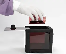 Heated anaesthesia box mouse side view with sliding lid open, researcher wearing lab glove holding tunnel with artificial mouse demonstrating easy placement.
