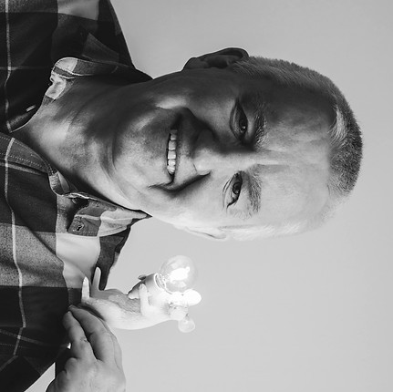 Harald, Electrical Engineer at Vigilitech holding a lit mouse lamp.