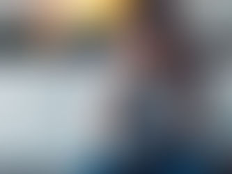 Woman showing signs of stress and burnout, sitting with eyes closed and holding her head.