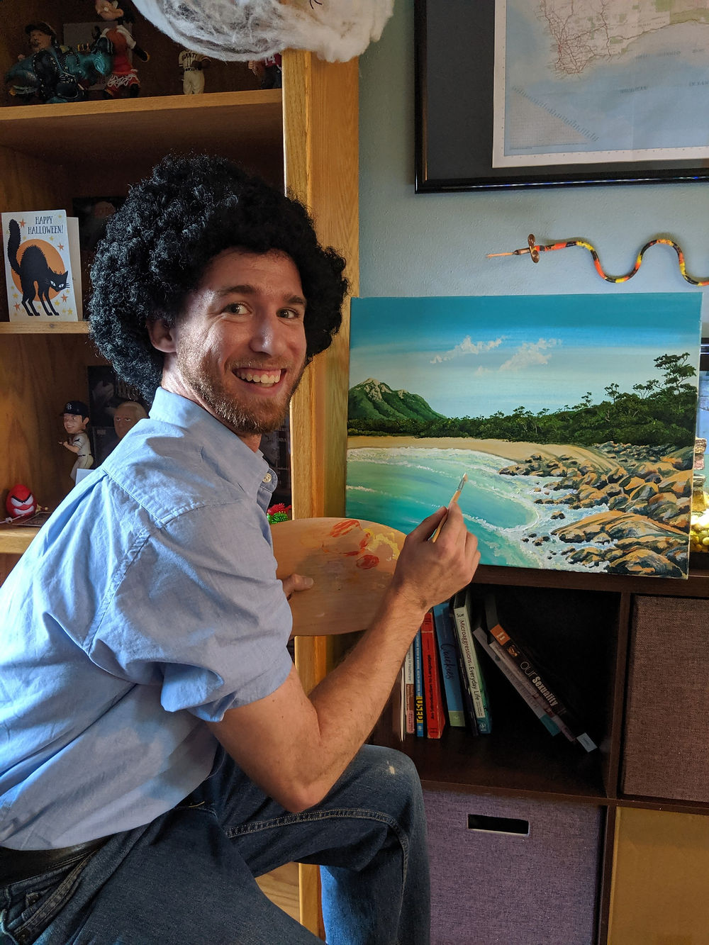 Adam Woodard dressed as Bob Ross while painting