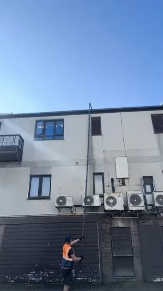 Man using gutter vacuuming in Newquay Cornwall