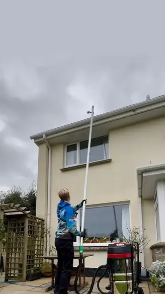 Man gutter vacuuming in St Autsell