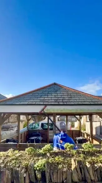 Man cleaning dirty fascia