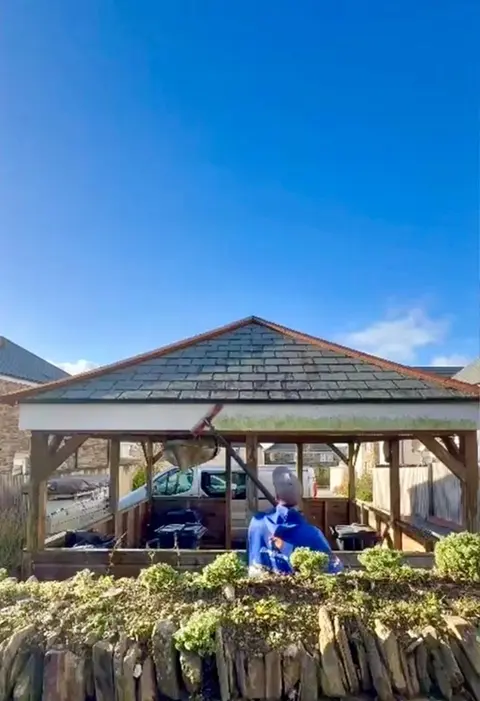 Man cleaning dirty fascia
