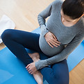 Pregnant woman on yoga mat