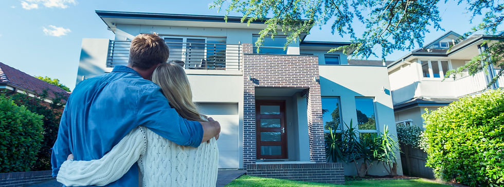 Couple hugs as they look at their first home. First time home buyers. Looking to purchase a home they are touring.