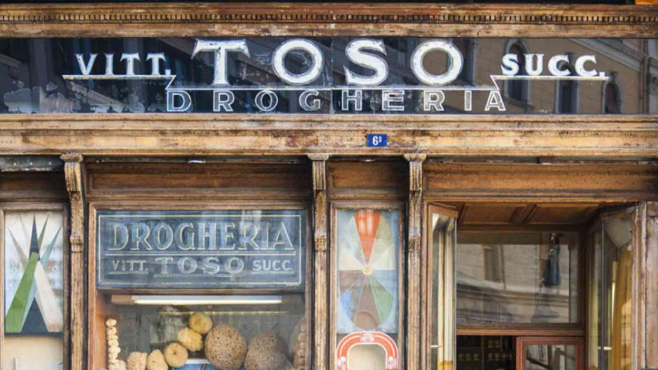 Drogheria Toso di Trieste. Scritte bianche su specchio scuro. Struttura in legno.