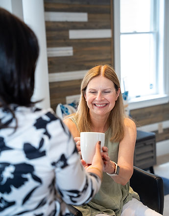Stylist at Hairvine serving a beverage during a personalized one-on-one salon experience in Armonk, NY.