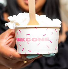 Cup of ice cream with whipped cream on top.