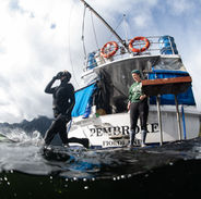 Scuba diving off the rear platform of the MV Pembroke