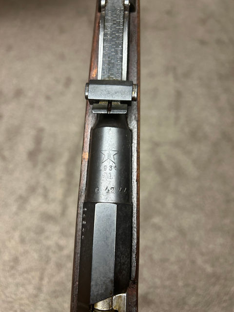 1934: the year of Donald Duck, nights involving long metaphorical knives, and this Mosin! Specifically, this rifle in many ways your standard Soviet M91/30. What’s notable about it however is that it did not stay Soviet forever; this rifle was one of many that fell into the hands of the Finnish Army. Given its age, it’s quite possible that it served on the Soviet side of the Winter War, but the 41 on the side of the barrel denotes that it was one of over 100,000 M91/30s captured during the Continuation War (but not necessarily in 1941). The rifle has clearly seen much use; in addition to several scuffs there is a fairly sizable dent in the stock just above the trigger. The bolt, magazine, cleaning rod, butt plate, and the back barrel band retaining spring are all Izhevsk produced. The bolt appears to be an M91 style as well; I wonder if the Finns intentionally put Imperial bolts in Soviet rifles due to their reputation of being smother? Interestingly the extractor is blued, which makes me think that it may have come from the parts lot the Finnish bought off the Germans. The markings on the stock are almost completely gone, faded and buried under the Finnish finish, but under light I was able to find the faint remains of what I think is a Tula star (you can judge for yourself in the photo). The aluminum escutcheons were also caked over with this finish in parts, which I scrapped off; in my defense, I originally thought it was dried oil because there was a ton of that caked on this rifle as well (it wasn’t cosmoline, we all know cosmoline when we see it lol). The trigger and cleaning rod are in the white, which gives this rifle a very attractive color palette of black, silver, and dark brown. It has the serial number copied onto the receiver as is the Finn way in addition to the SA mark. But perhaps most interesting of all is that this rifle came with the original sling collars still in the stock. I quickly removed them for protection, but it’s a cool thing that I haven’t seen often. The last photo shows the rifle as I received it. Other than that, the rifling is strong and counterbored. I just wish that she could talk. Maybe if the guys at Mosin.fi come across her records, then she just might. Until then, she will just remain a nice example of one of the most common types of Mosin in the Finnish arsenal despite today only being remembered as the rifle used against them.