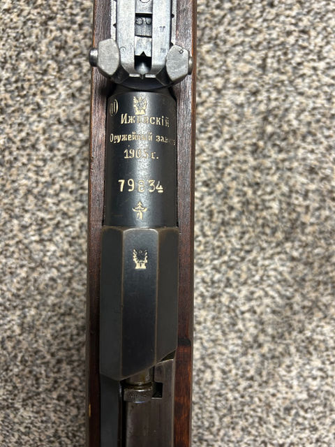 This M91 is currently the oldest rifle I own, at least in terms of actually knowing when it was made (darn you Turkey for changing the barrel on my Gewehr 88/05/35 in 1941 without letting me see the original date first). It was made at Izhevsk in 1905, meaning that it possibly got to see the tail end of the Russo-Japanese War as well as the 1905 Revolution, though it’s nearly impossible that it saw any direct service in the former. One way or another it then made its way to Finland; given the lack of evidence of being captured by another nation it was probably one of the ones already in Finland when it became an independent nation before immediately joining the “Fought a Civil War Right After WW1” Club. The rifle received a Finnish made (or more specifically, whoever used a Z in a circle with crossed cannons as their mark) two-piece stock with a toe splice sometime before or during the Second World War. Eventually, a large chunk of the stock was taken out under the handguard; we will likely never know if this was due to an incident involving Soviet artillery or too much sahti. What is known is that some of the scuff marks and the white streak on the stock were the result a rough meeting with concrete and the improper use of window cleaner respectively; this is known because these things were my fault. I am considering touching up these parts of the stock with the correct Finnish finish to atone for my younger self’s negligence as a 120th birthday present to this rifle. Other than the stock, a scrubbed floor plate, and the SA mark added after late 1942, the rifle still retains a lot of its Tsarist features. Interestingly, the arshin markings on the rear sight were not crossed out when they were converted to meters. The bore is clean, but predictably counterbored. The cocking piece was made at Sestroryetsk, and the barrel bands are of the retaining pin type but are held in by retaining screws.