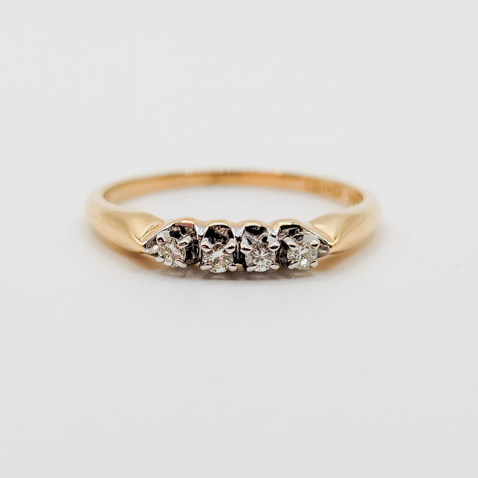 A 14k yellow gold and white gold diamond ring featuring four round natural diamonds totaling 0.10 carats