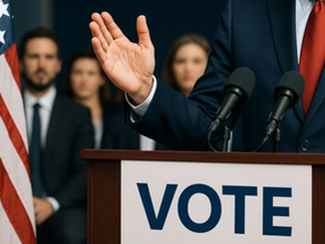 Man at podium with people standing behind him next to an American flag.