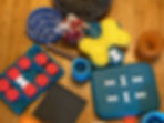 A collection of dog enrichment toys and puzzles on the floor