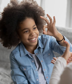 Smiling small African American deaf disabled girl show gesture with hand practice sign lan