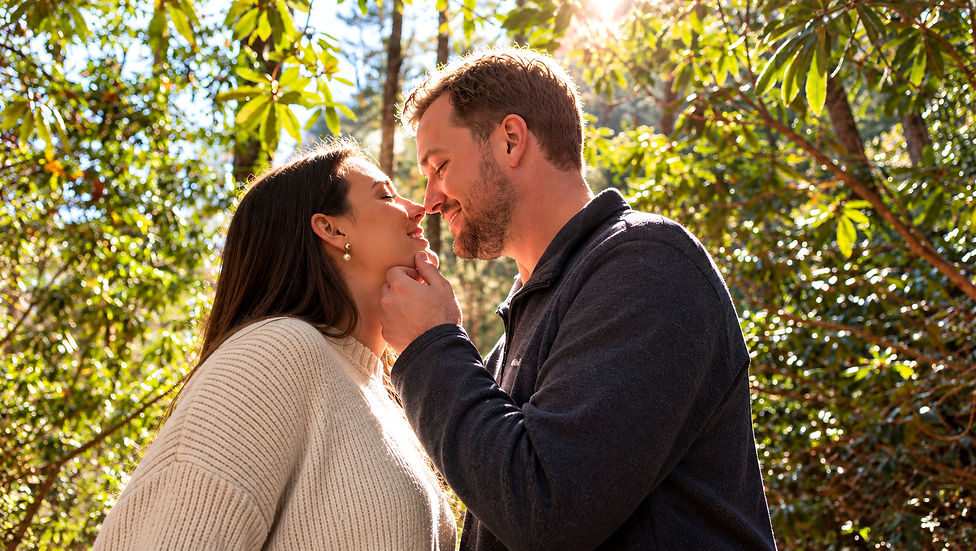 Engaged couple sharing a romantic eskimo kiss moment during an outdoor engagement session