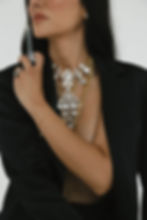 Lindsay Bright, double board-certified nurse practitioner and expert injector at Flawless Aesthetics in Chattanooga, holding a syringe of dermal filler while showcasing her sculpted jawline and profile.