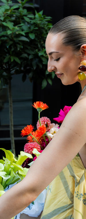 Carrying sunset coloured flowers in Shoreditch, London