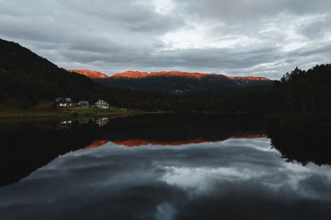 View of a lake with mountains in the background at sunset