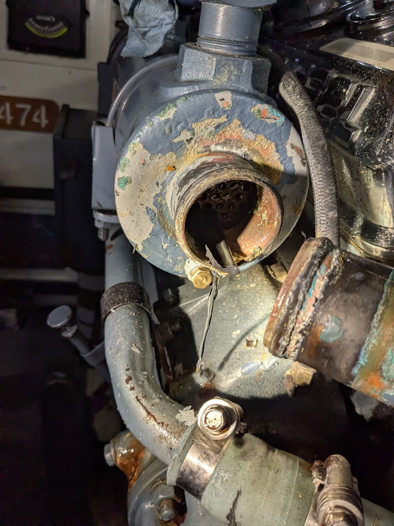 Heat exchanger end cap revealing a broken impeller vane caught upstream in the cooling system of a Detroit diesel.