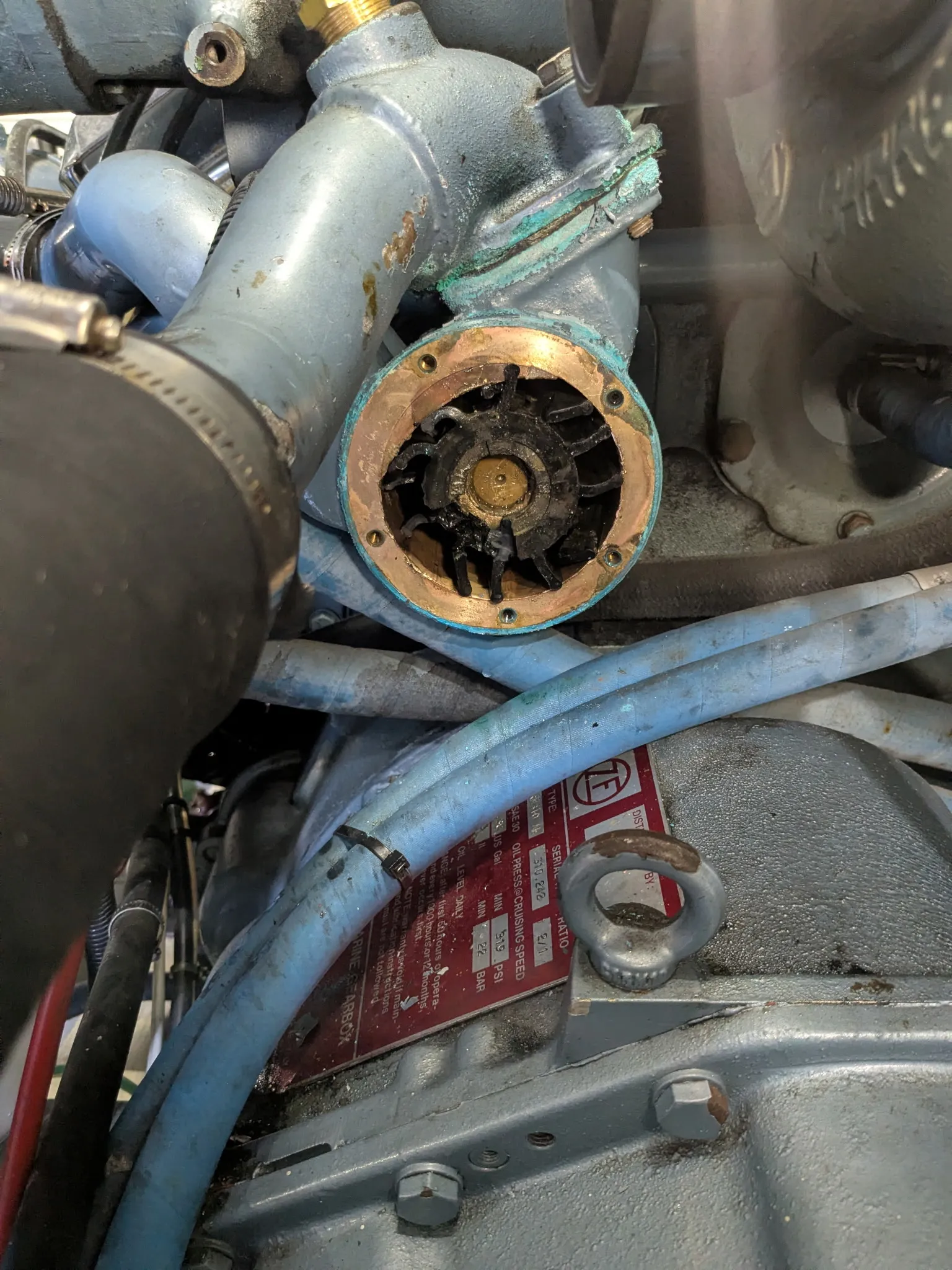 Inside a Detroit diesel water pump housing, a destroyed impeller stuck to the shaft with broken vanes