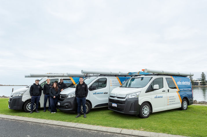 Three branded vans with staff standing in front on grass. Signage designed by Natalie Jayne Creative