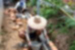 Construction workers place bricks into mortar on a construction site.