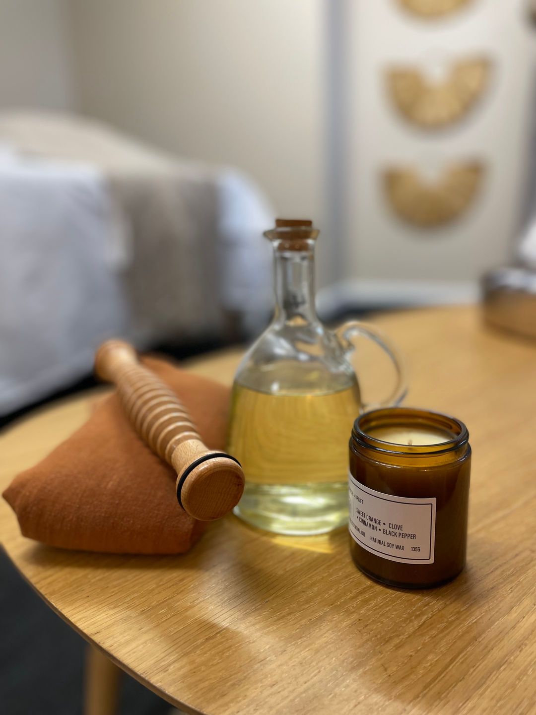 Postnatal massage oil and candle, massage studio
