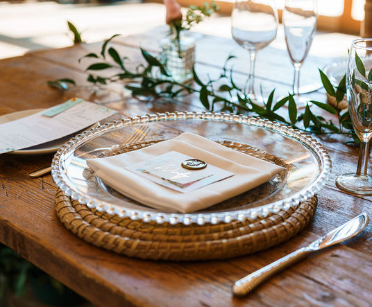 Gold acrylic wedding charger plate on luxury wedding reception table