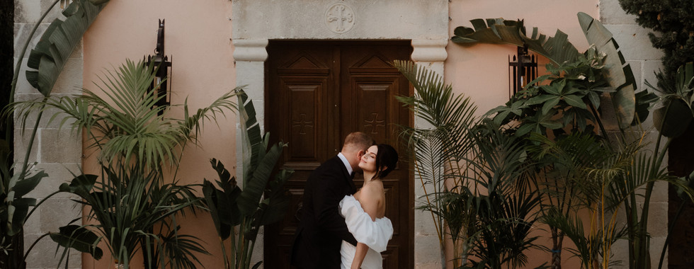 Joe and Georgia - Agreco Farm , couple standing in front of Chapel in crete on weddiing day