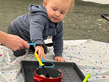 messy play wakefield - boy exploring the porridge