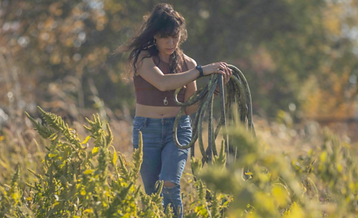 ENVIRONMENTALESE ER Woman Walking in Field.png