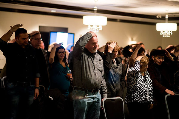 crowd following hypnotist instructions
