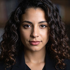 Firefly_Create a professional headshot of a latina in her early 30's with tight curly, dar